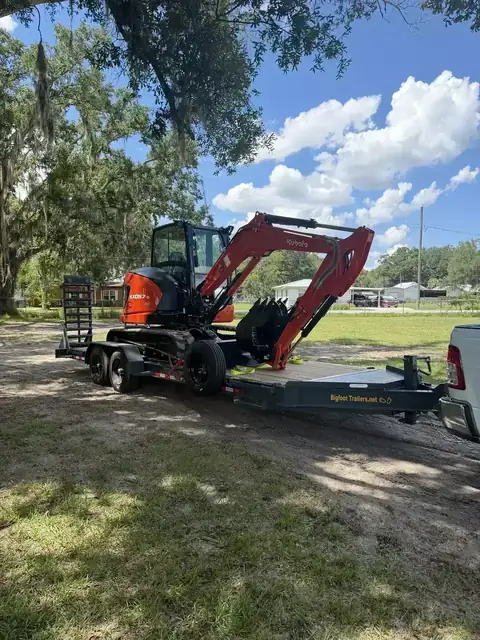 Kubota mini excavator on a land clearing job site in Polk County