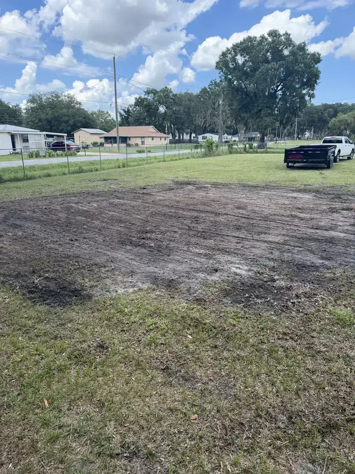 Property after brush clearing with soil ready for leveling and cleanup