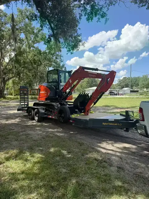 Kubota mini excavator on a land clearing job site in Polk County